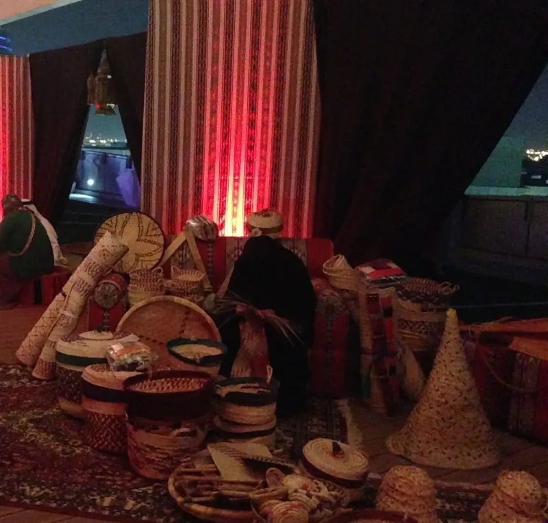Traditional heritage display of woven baskets and crafts in a decorated tent