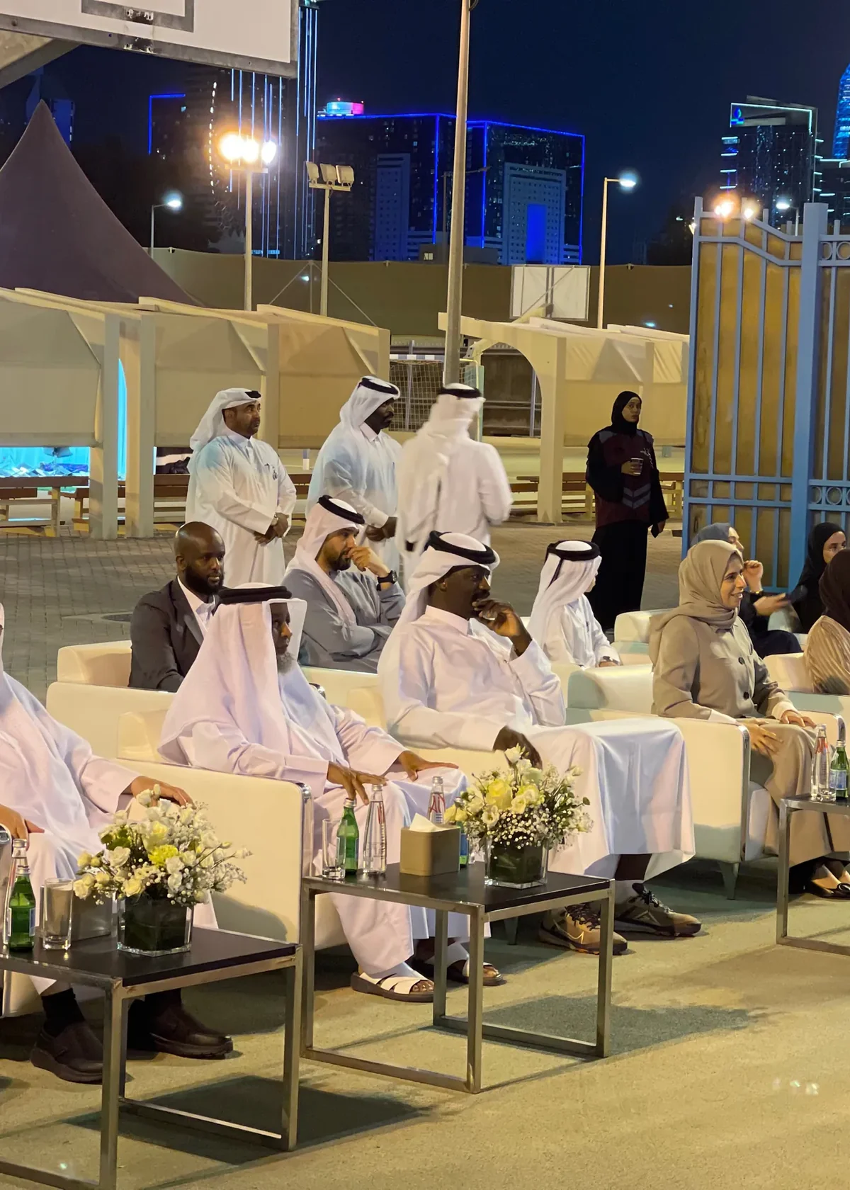 Guests seated on white sofas at the Bunyan Center launch with the Doha skyline behind