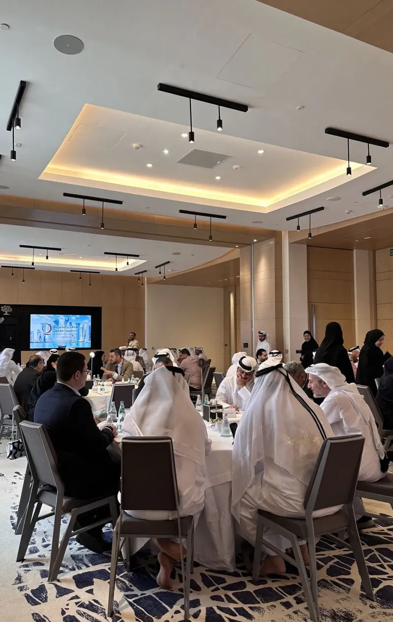 Executive team seated at tables during a team-building programme in a ballroom