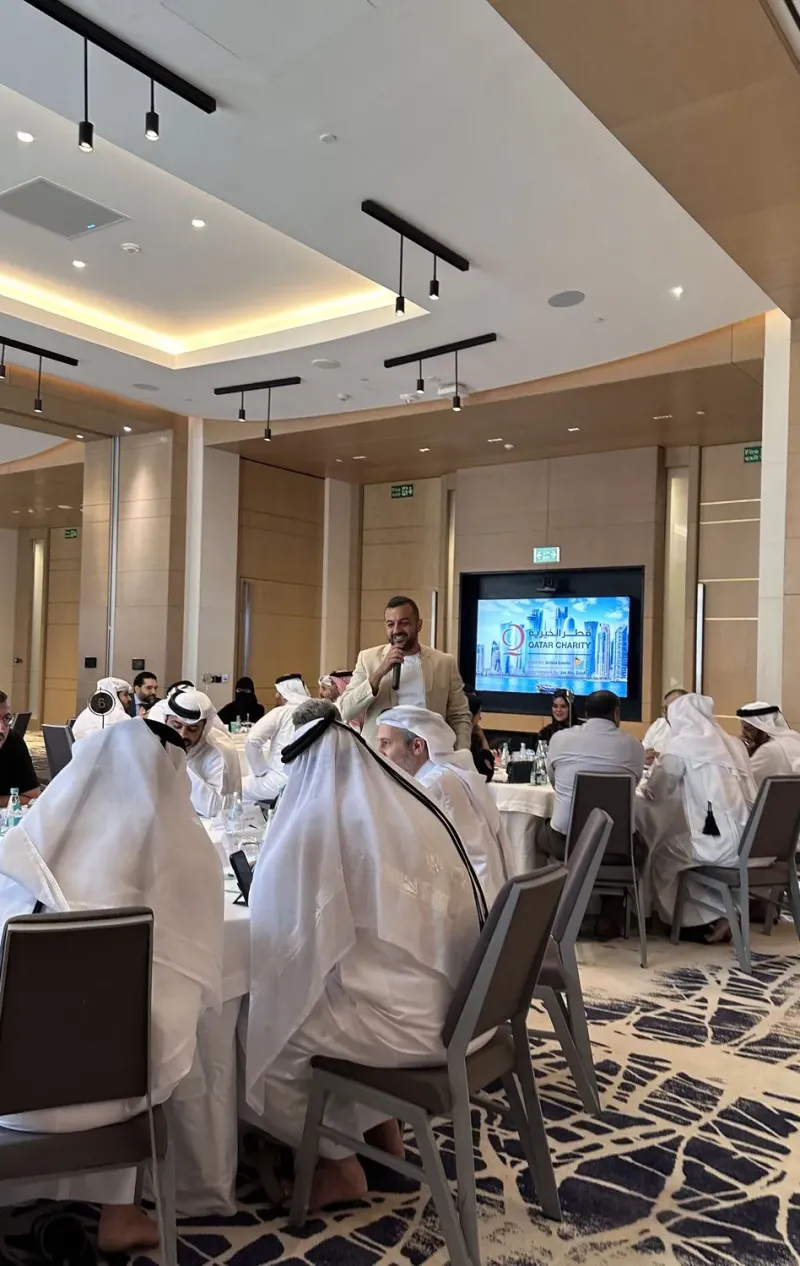 Guests seated at round tables in an elegant hotel ballroom