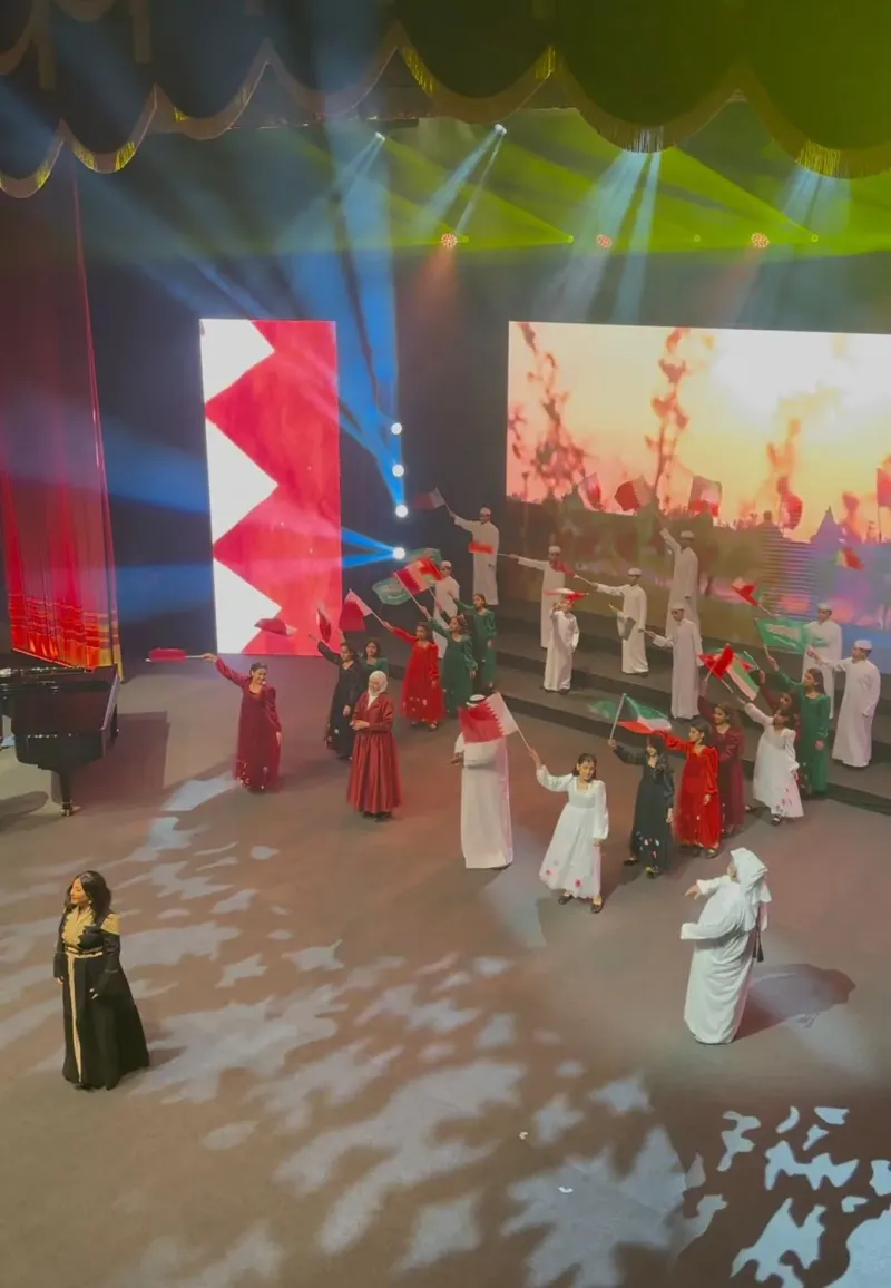 Operetta cast performing on stage with a flag and fiery LED backdrop